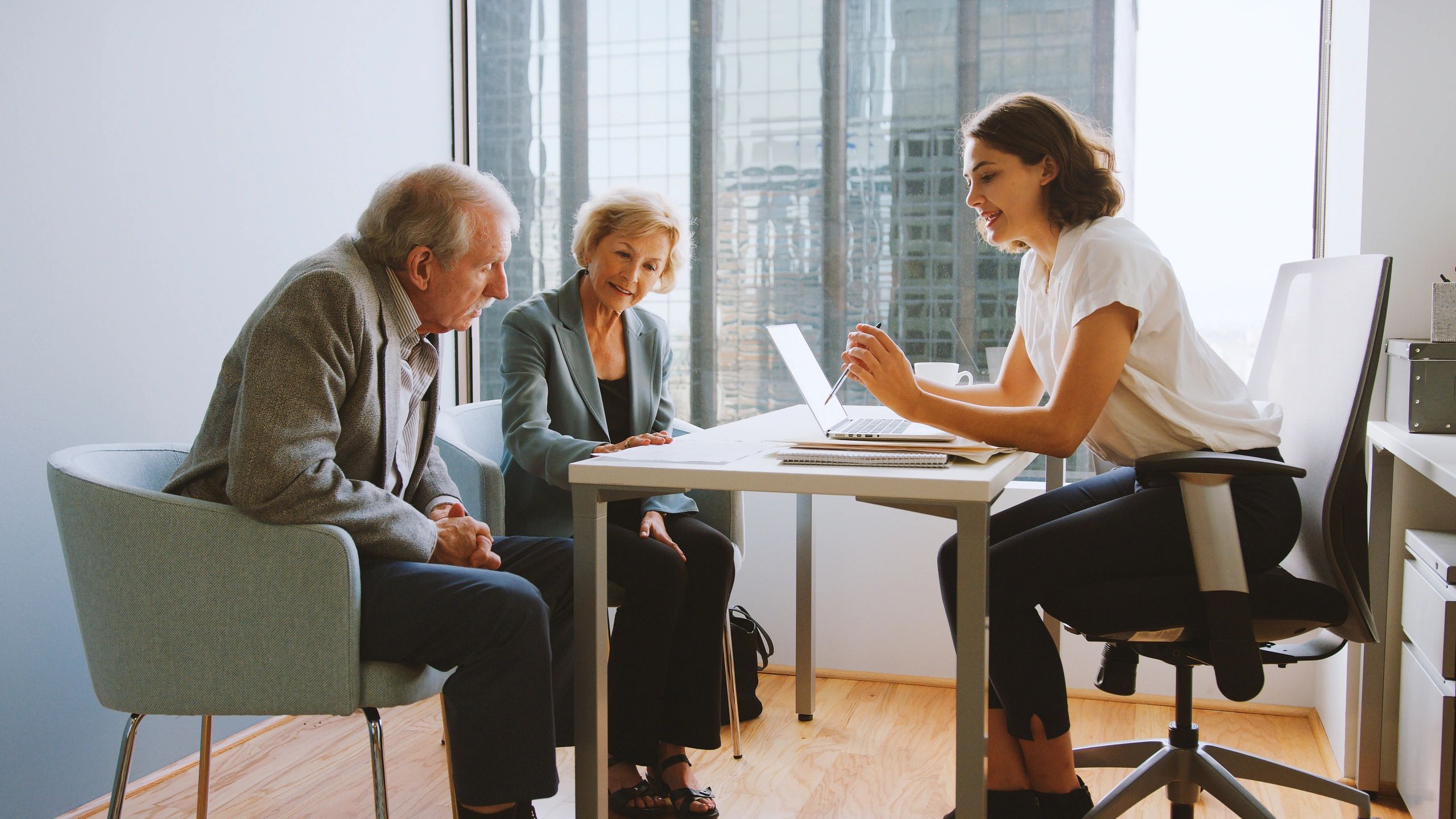 Consultants in discussion with clients in an office